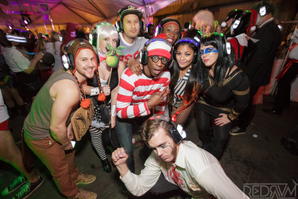 San Francisco Halloween dance party with costumed attendees and DJ lights