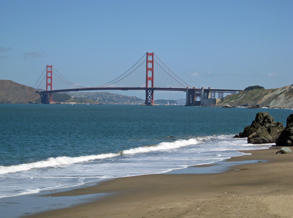 Golden Gate Bridge framed by the cliffs of China Beach. Quiet Beaches in San Francisco: Best Hidden Spots for Peace and Relaxation