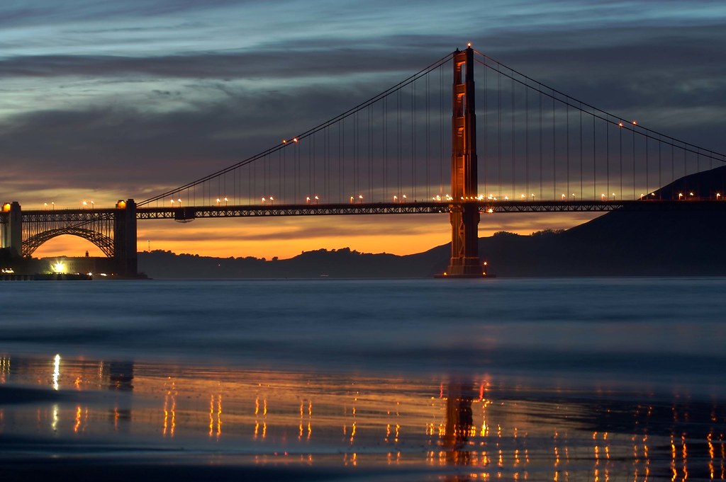 Stress-Free Things to Do in San Francisco =A serene view of Crissy Field beach at sunset with the Golden Gate Bridge in the background