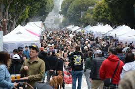 Crowds walking among art booths at Union Street Festival during San Francisco street fairs September 2025