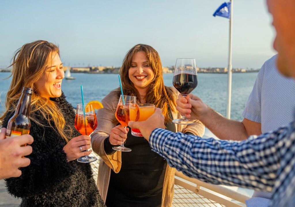 Friends enjoying champagne on deck during Labor Day boat cruises San Francisco