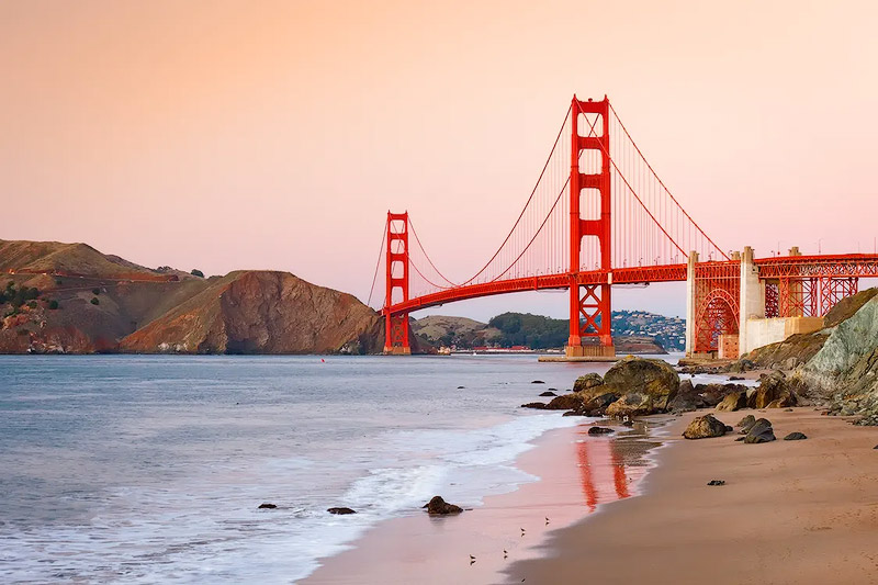 Golden Gate Bridge view from Baker Beach at sunset during summer