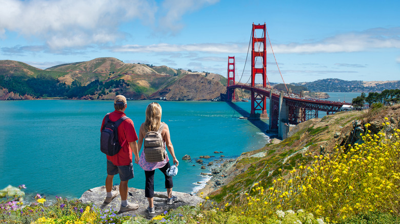 Hiker overlooking the Golden Gate Bridge from Lands End.