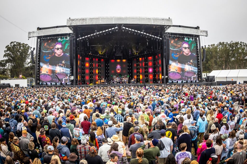 Musicians on stage at Golden Gate Park with a packed audience