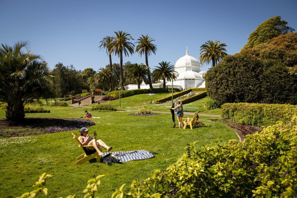 People enjoying a picnic at Golden Gate Park’s Conservatory of Flowers lawn