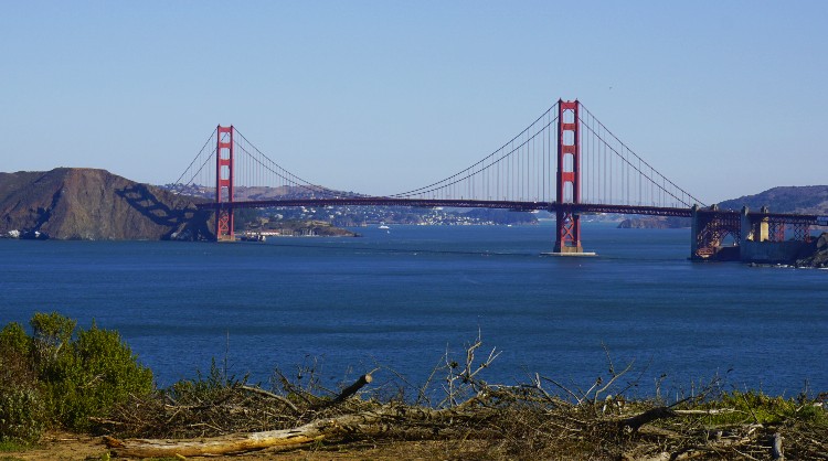 People hiking Lands End trail with Golden Gate Bridge in the background
