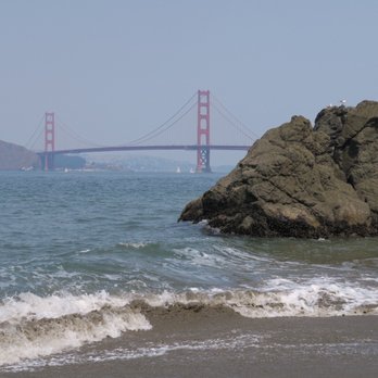 Small group exploring tide pools at China Beach in San Francisco