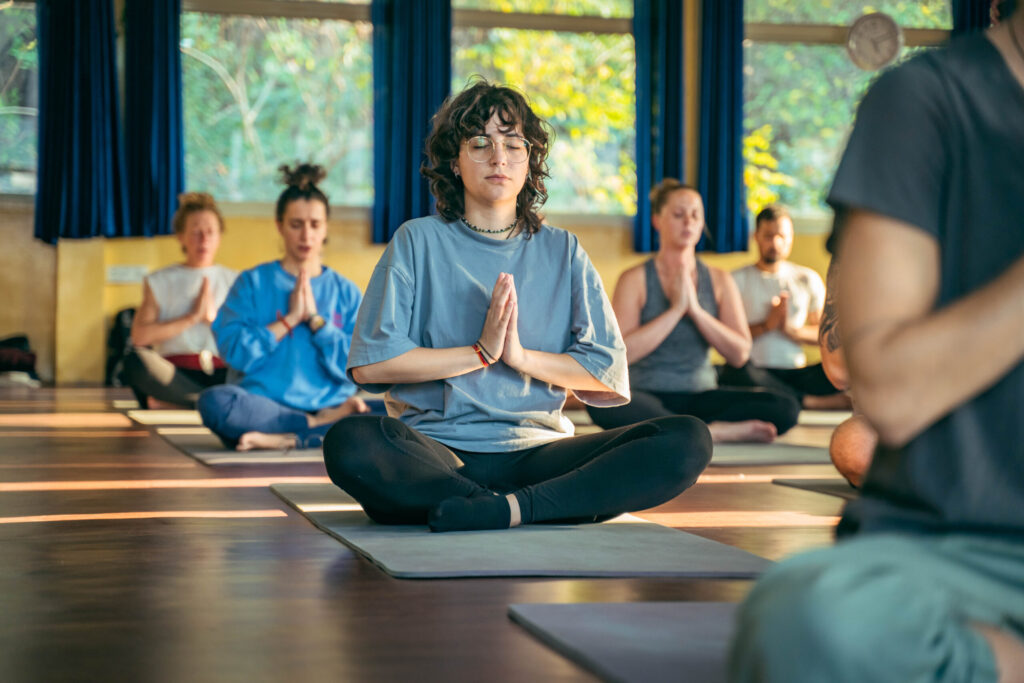 Students practicing yoga followed by seated meditation