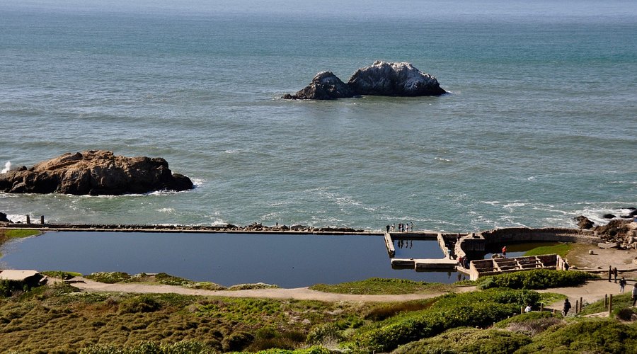 Sutro Baths ruins with ocean waves crashing nearby.