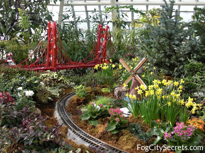 Tourists admiring exotic plants inside the Conservatory of Flowers in Golden Gate Park