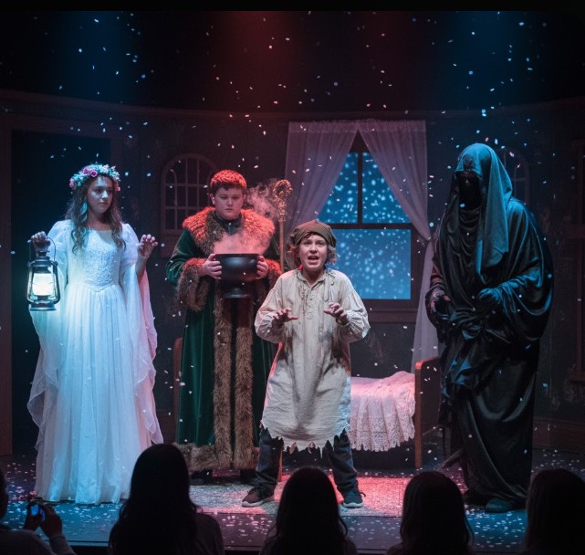 Child actor portraying Scrooge surrounded by ghosts in A Christmas Carol at San Francisco’s Young Performers Theatre.