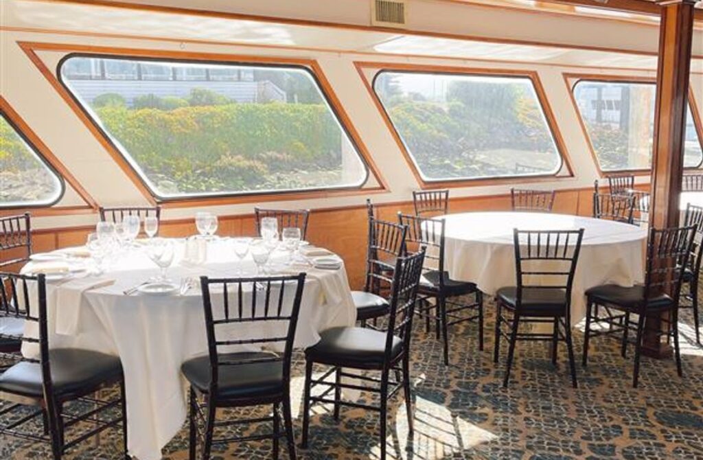 Elegant dining room aboard a Hornblower cruise with holiday table settings.