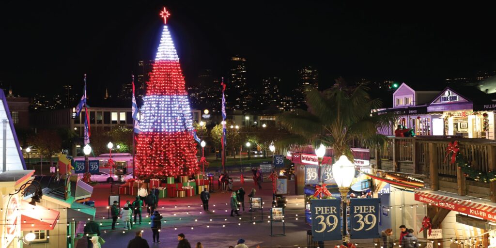 Pier 39 holiday tree lighting 2025 with Christmas lights and visitors