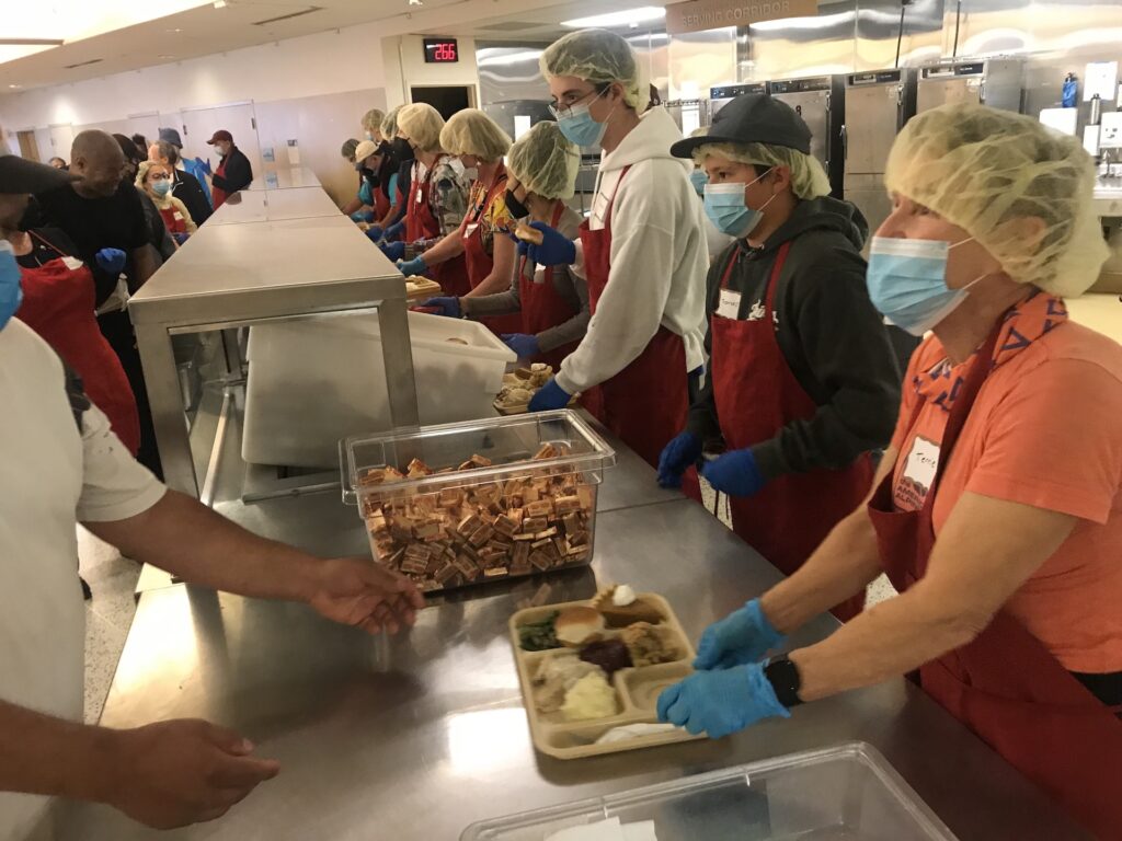 Volunteers preparing Thanksgiving meals at St. Anthony’s Foundation kitchen.