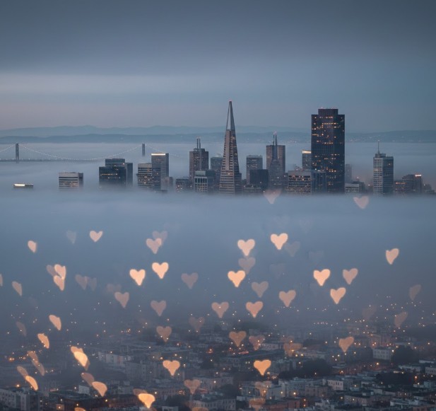 Foggy skyline view with heart-shaped bokeh lights